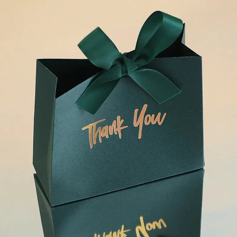 Two teal mini gift boxes with gold Thank You text and green satin ribbon