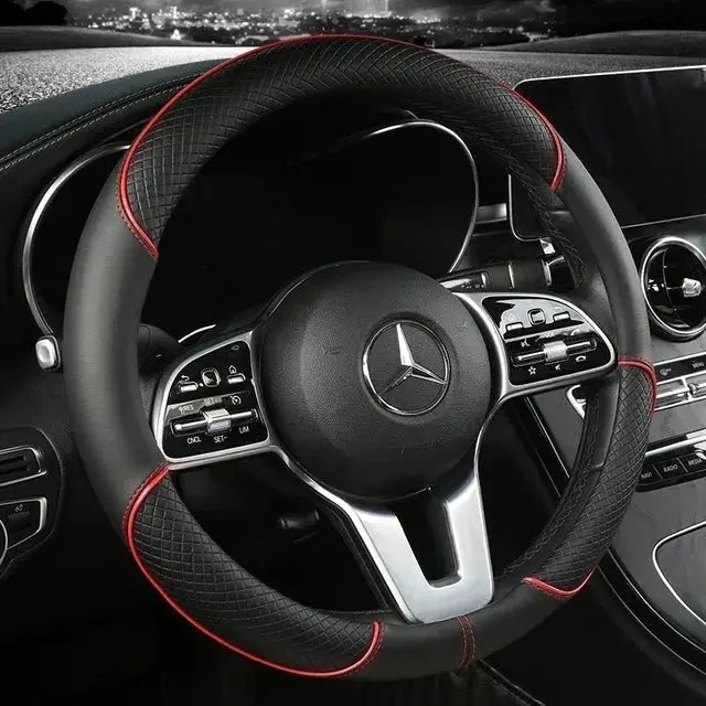 Steering wheel cover in black microfiber leather with red stitching, 38cm diameter.