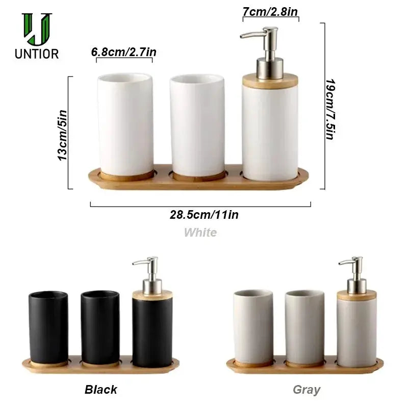 Ceramic bathroom set by UNTIOR on wood tray with soap dispenser and toothbrush holders in white; black and gray.
