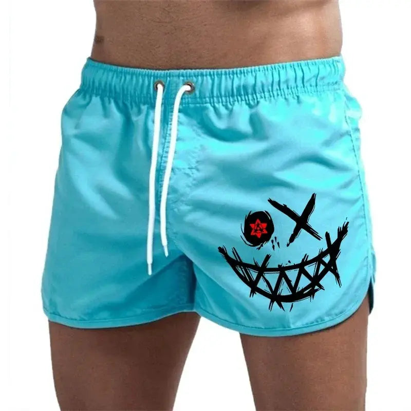 Men's turquoise board shorts with white drawstring and a black smiling face graphic