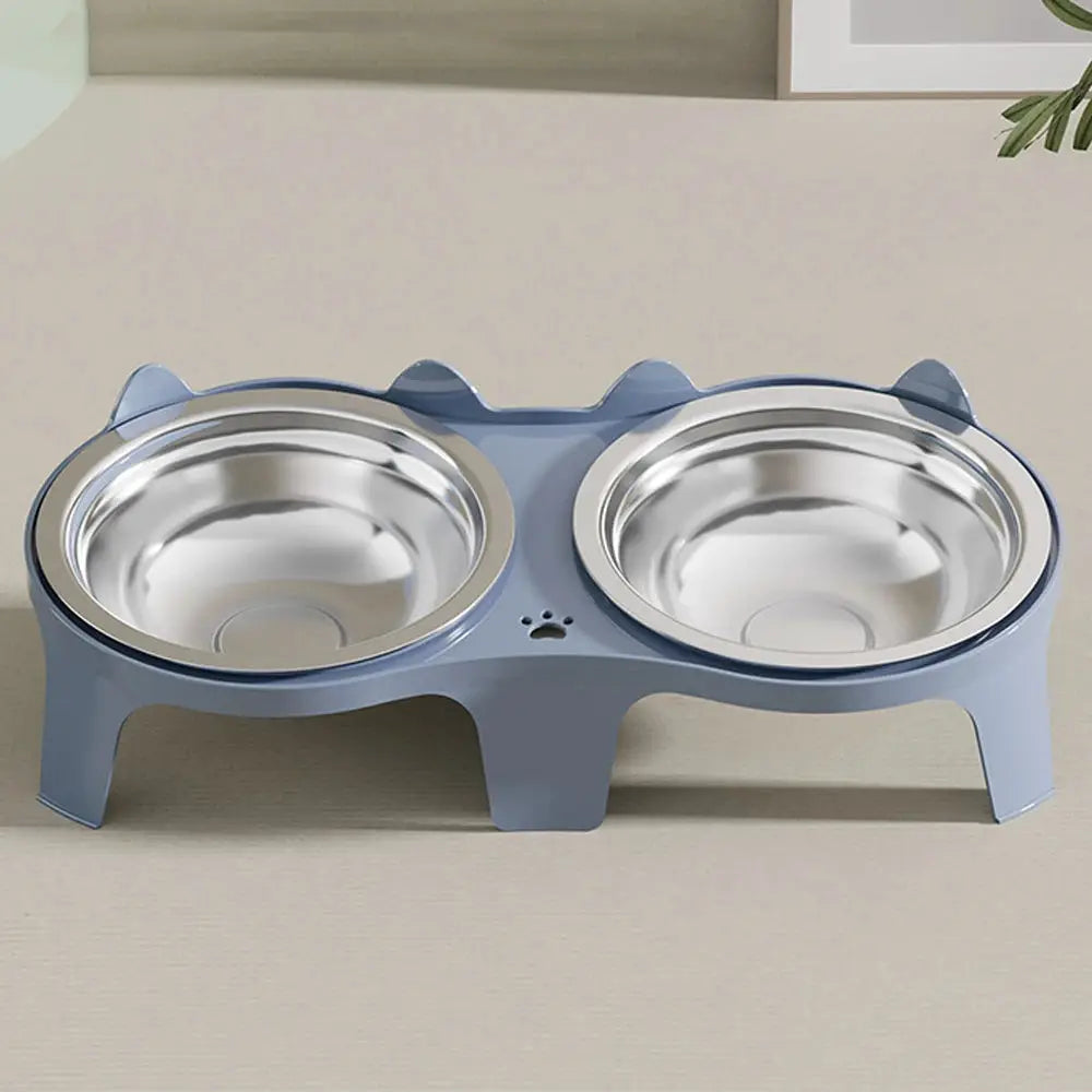 Two stainless steel pet bowls on a blue anti-tip stand with paw-print detail