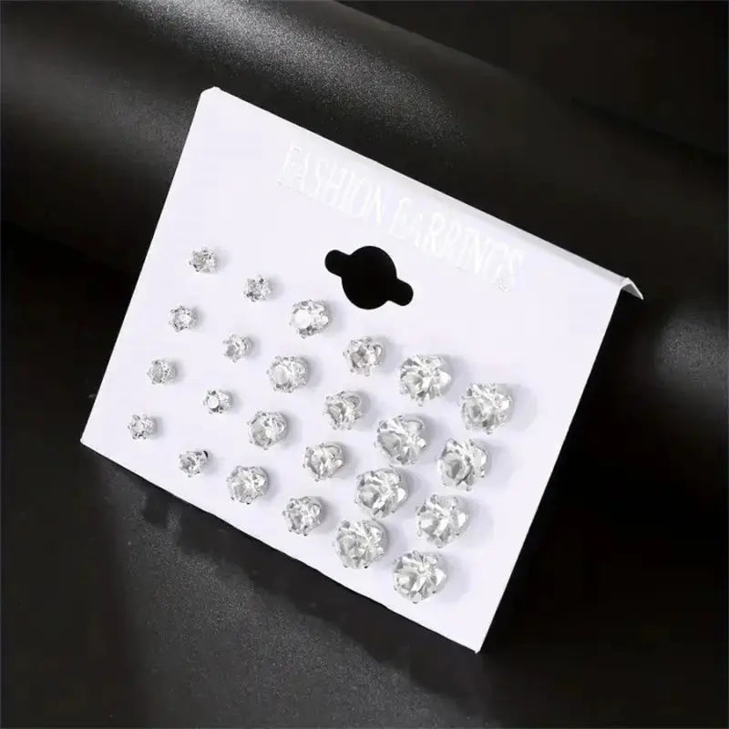 12-pair six-claw zircon stud earrings set on a white display card; clear, shiny crystals in various sizes