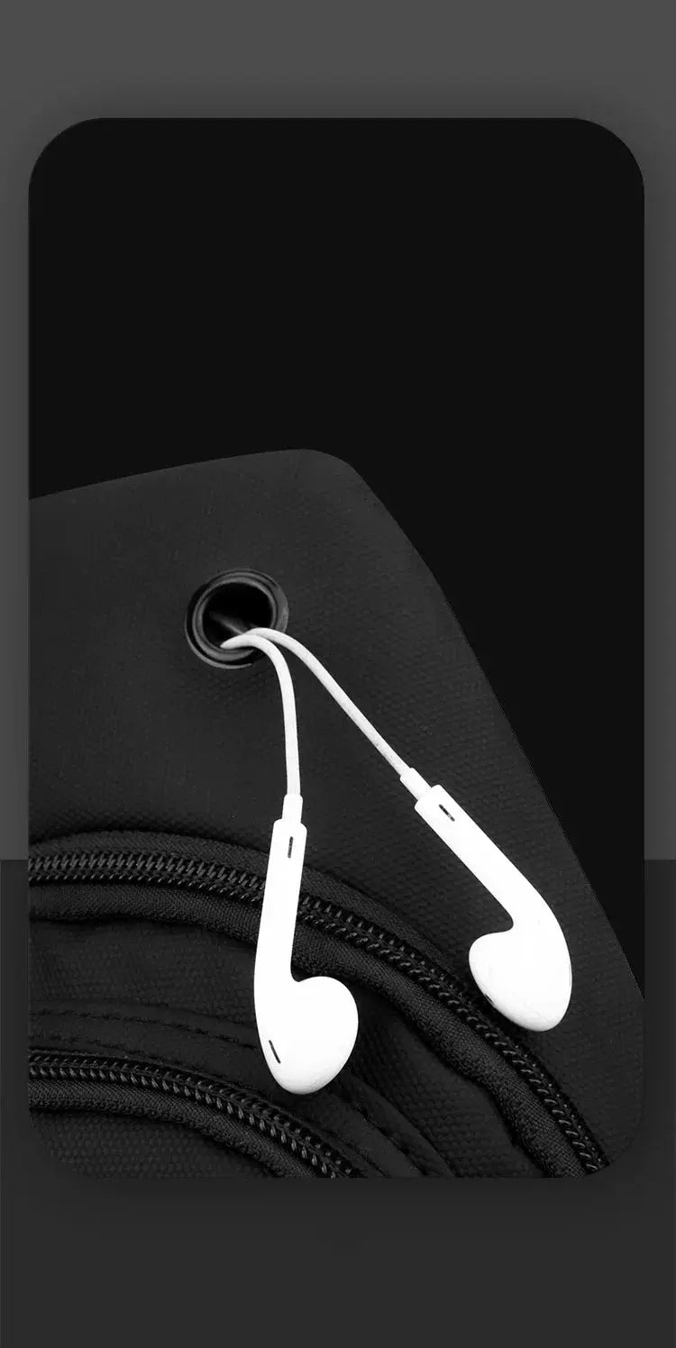 Lightweight black nylon chest bag with multiple zippers; white earbud headphones draped over it.