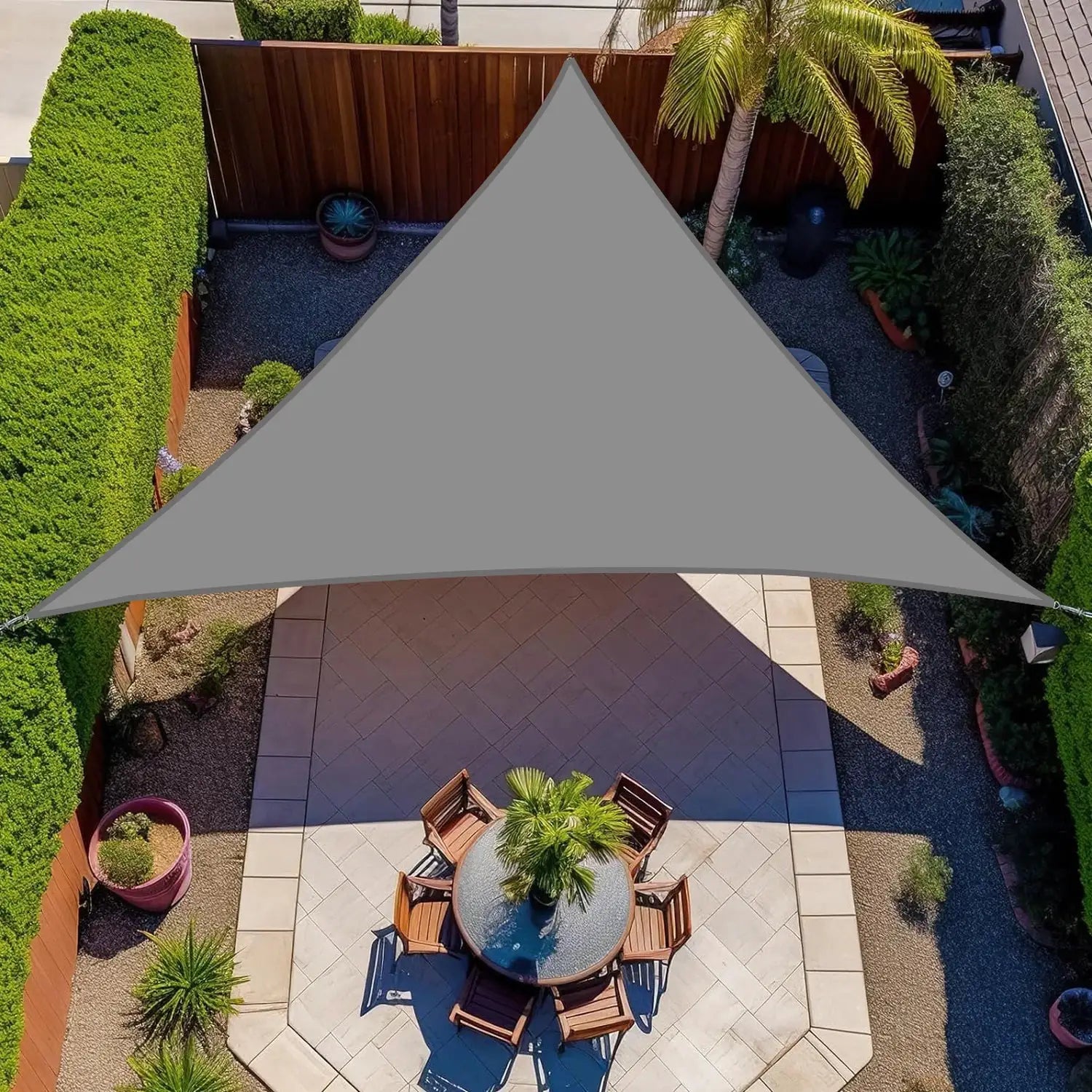 Triangle sun shade sail by Simples Market, gray waterproof UV canopy over outdoor patio dining area.