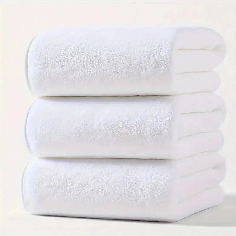 3-piece white bath towel set stacked; large towels.