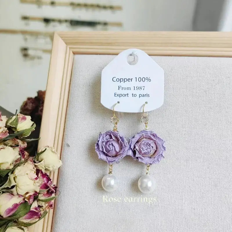 Pair of Elegant Immortal Rose Long Earrings with purple epoxy rose petals and pearl drops