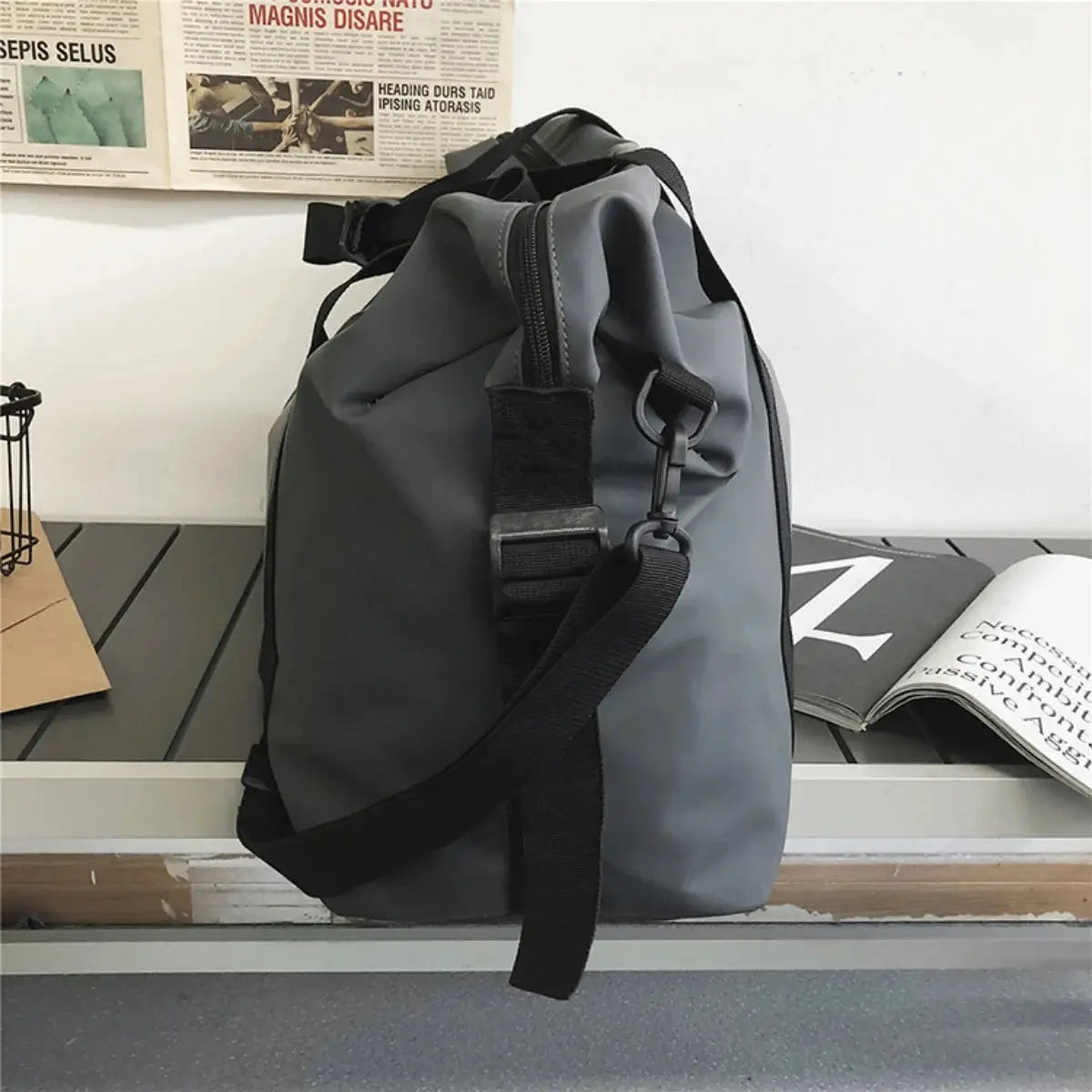 Handheld travel bag, gray with adjustable black crossbody strap and side clip