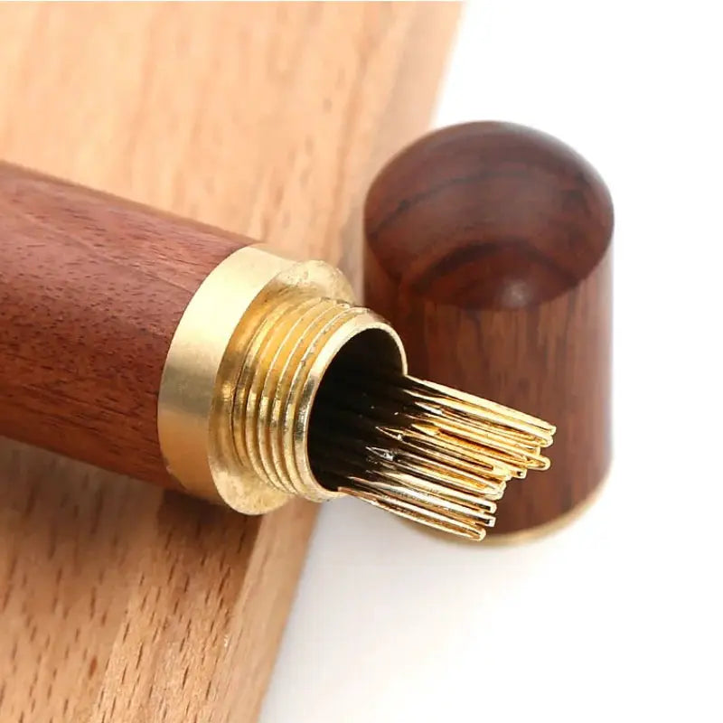 Self-threading sewing needle punch tool with wooden handle and brass collar; gold-tone needles