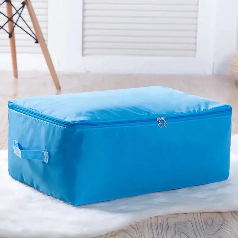Large blue zipper clothes organizer bag by Simples Market for bedding storage with side carry handle
