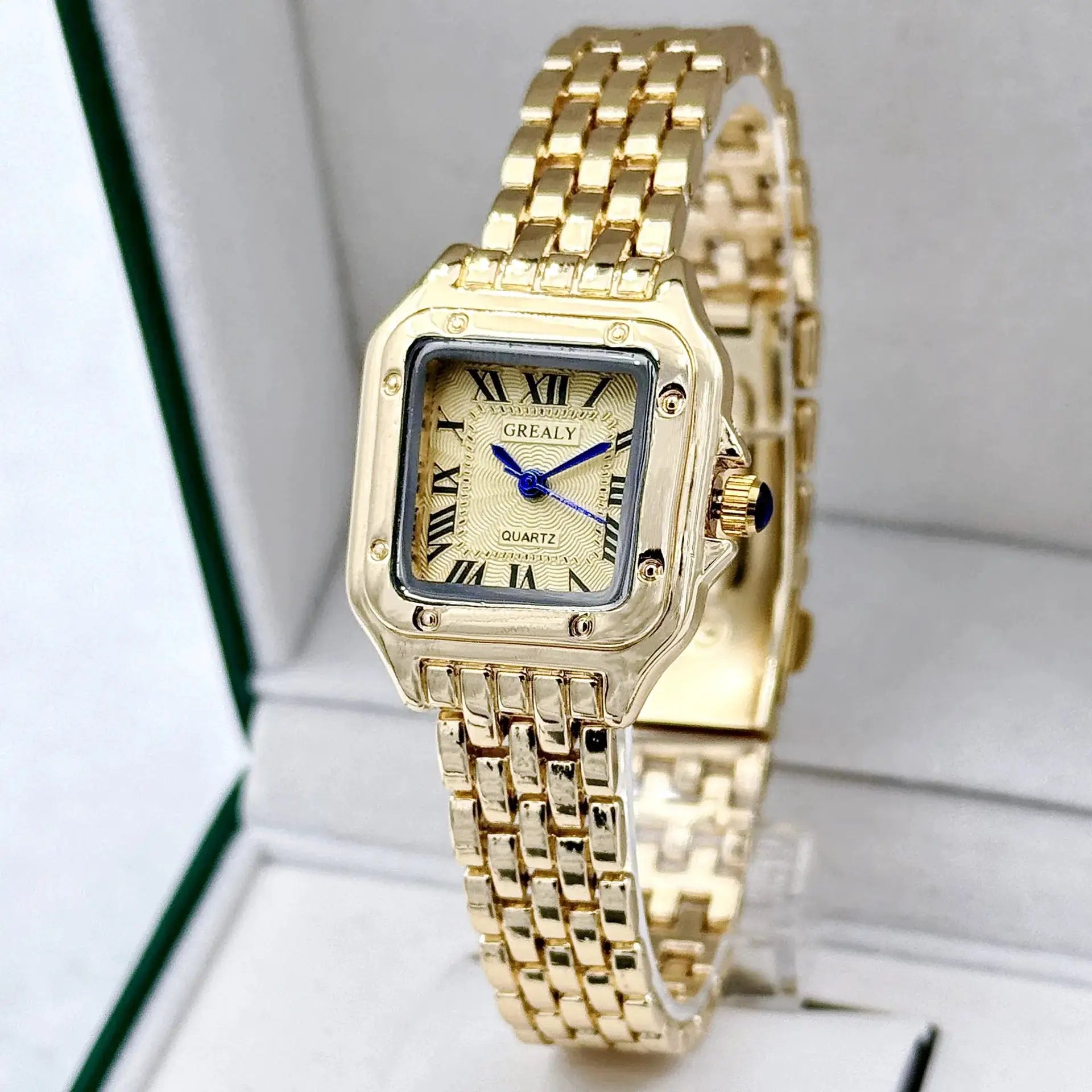 Gold-tone women's wristwatch with rectangular dial, Roman numerals, blue hands GREATLY.