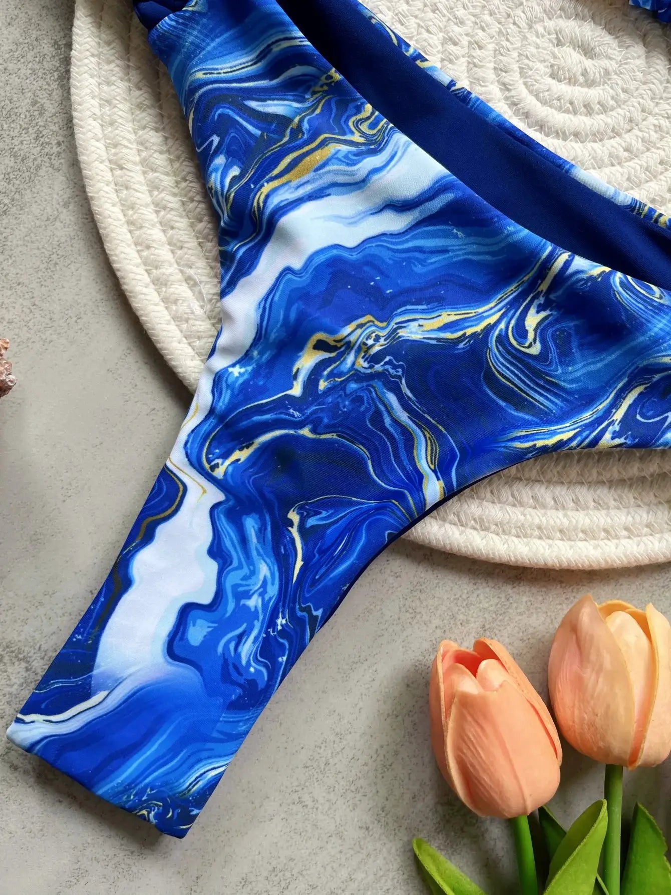 RUOTONSEPT blue marble print halter bikini set with high-cut bottoms.