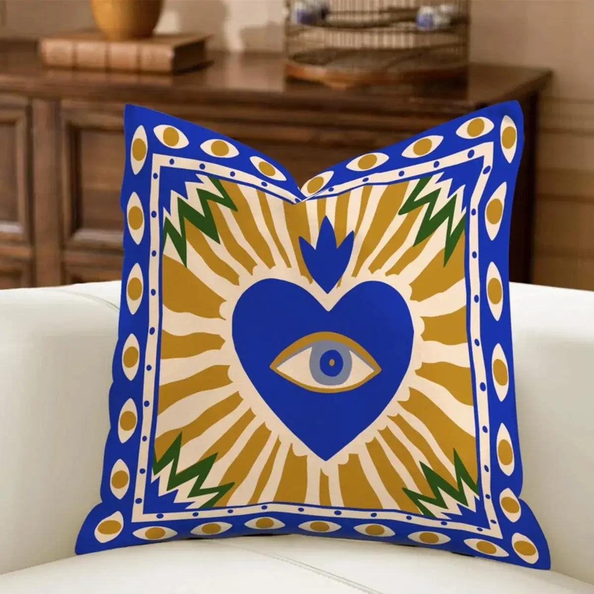 Pillow cover by Simples Market; minimal boho sun motif with blue border, gold rays, and blue heart with an eye.