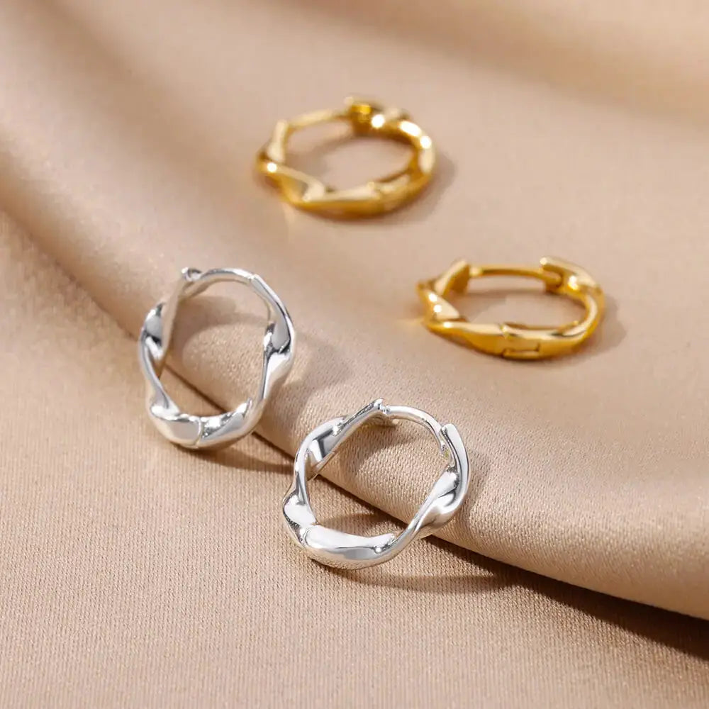 Set of four twisted round stainless steel hoop earrings in silver and gold tones