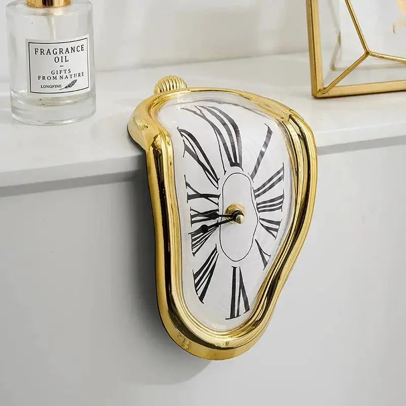 Surreal melting wall clock with gold-tone frame and Roman numeral dial