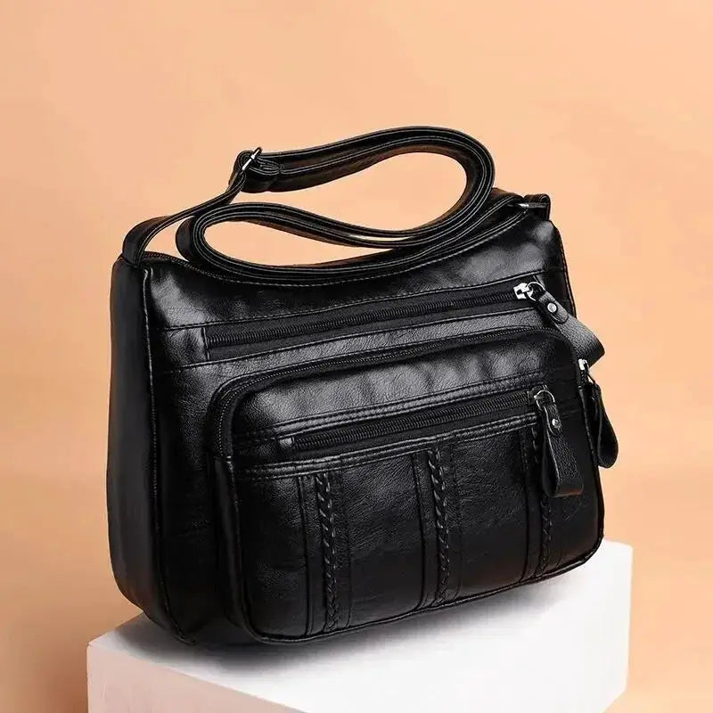 Crossbody bag for women, black leather-look with multiple zip pockets and top handle, large capacity