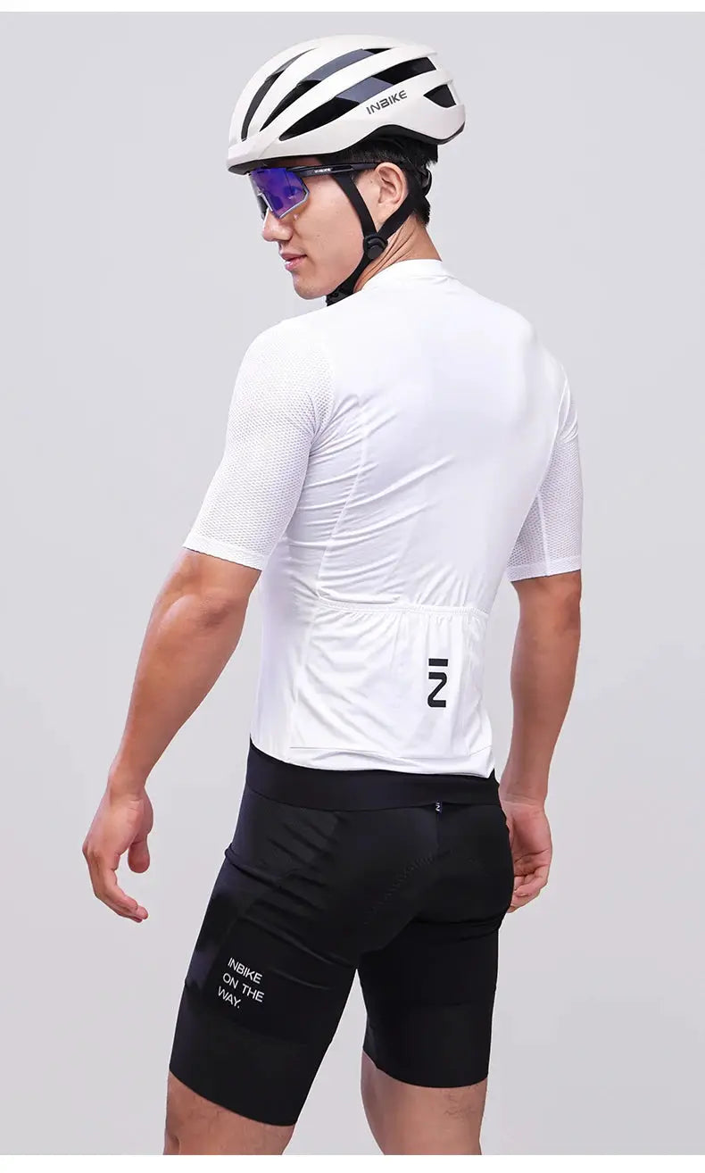 INBIKE men's MTB cycling bib shorts in black with white logo, worn with white jersey and helmet