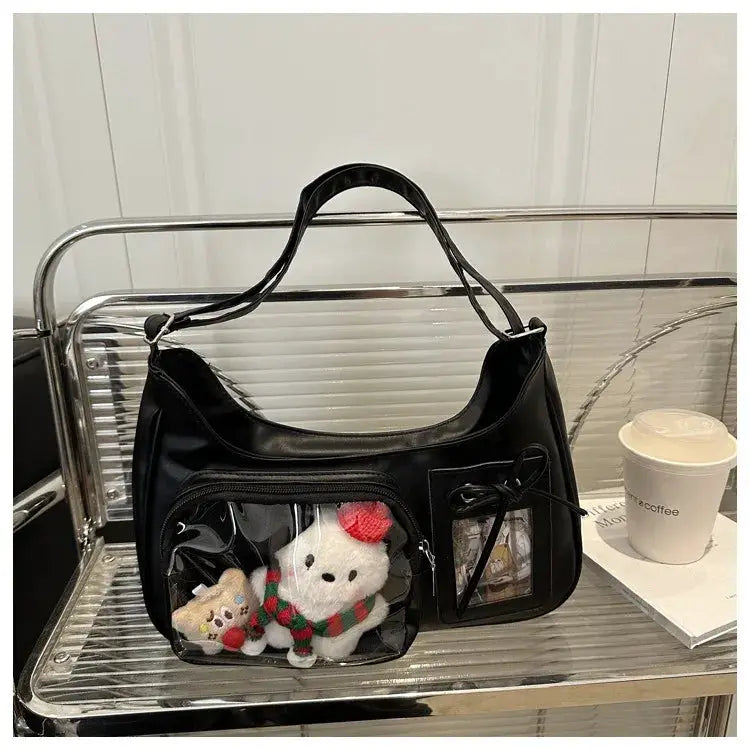 Black Y2k Harajuku shoulder bag with clear front pocket showing 2 plush toys