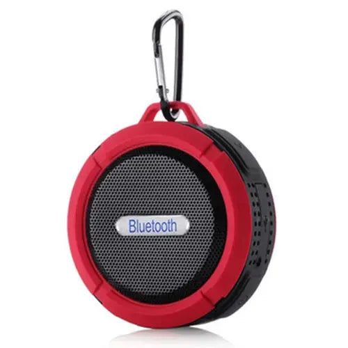 Portable waterproof Bluetooth speaker, circular red frame with black body, metal grille and carabiner clip