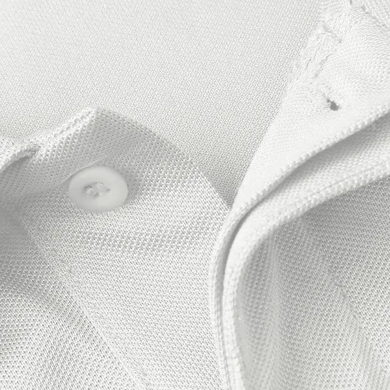 White men's polo shirt close-up with button and collar, Simples Market.