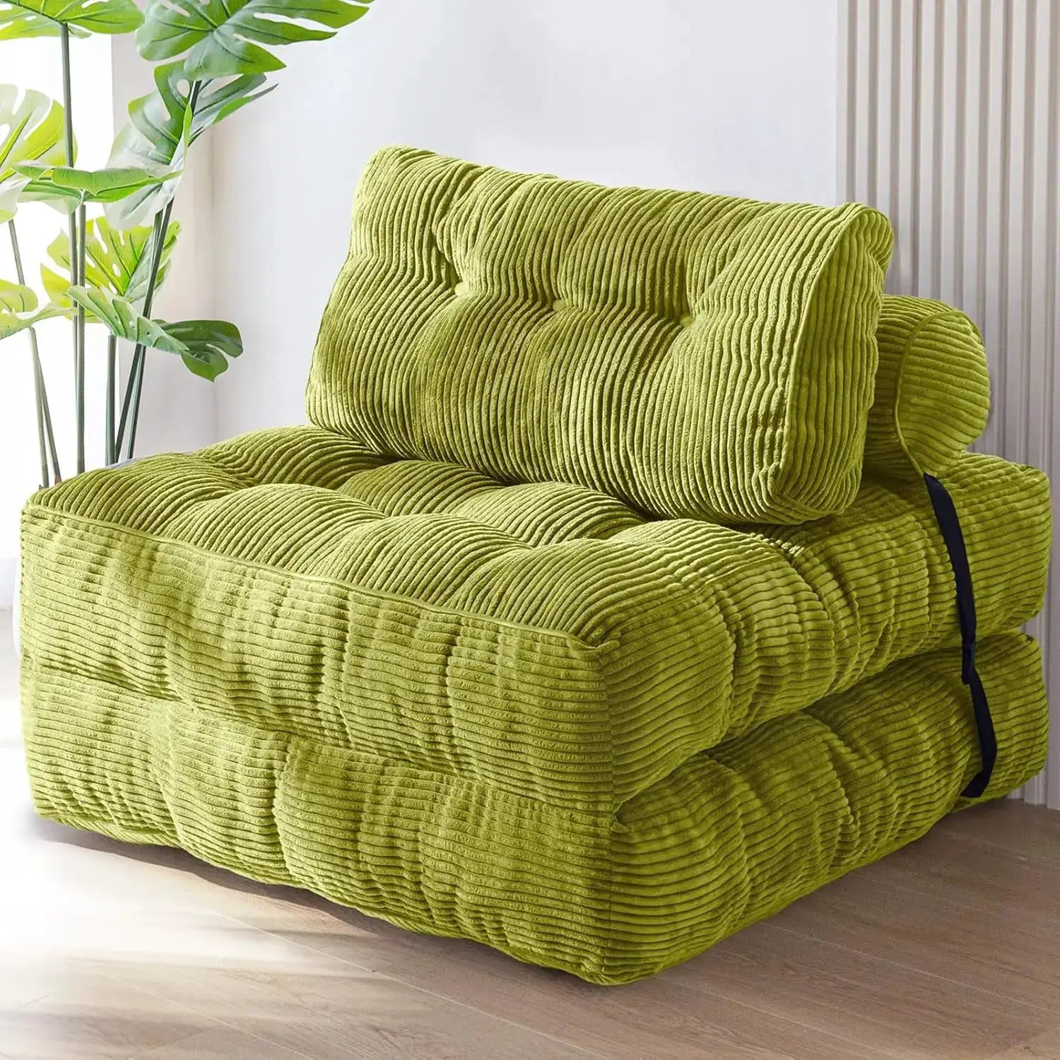 Folding sofa bed in lime green corduroy fabric with pillow, portable fold-out lounge chair.