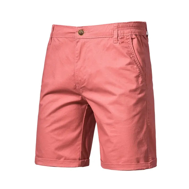 Men's pink cotton shorts with button front, belt loops, and rolled cuffs.