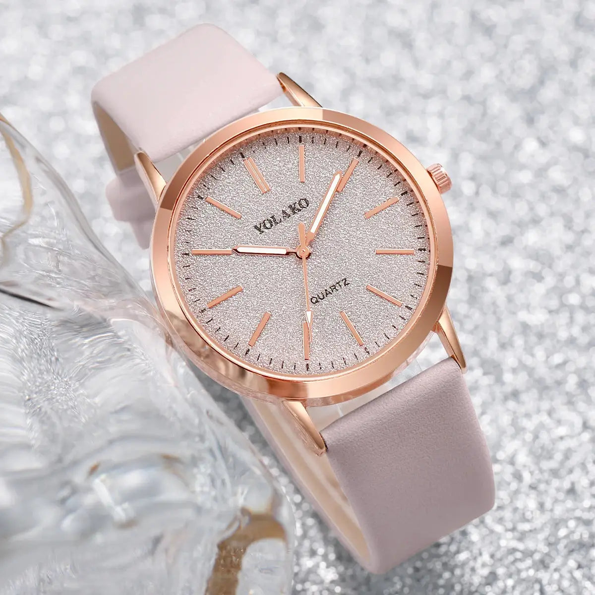 Women's rose-gold tone quartz watch with glitter dial and pink leather strap.