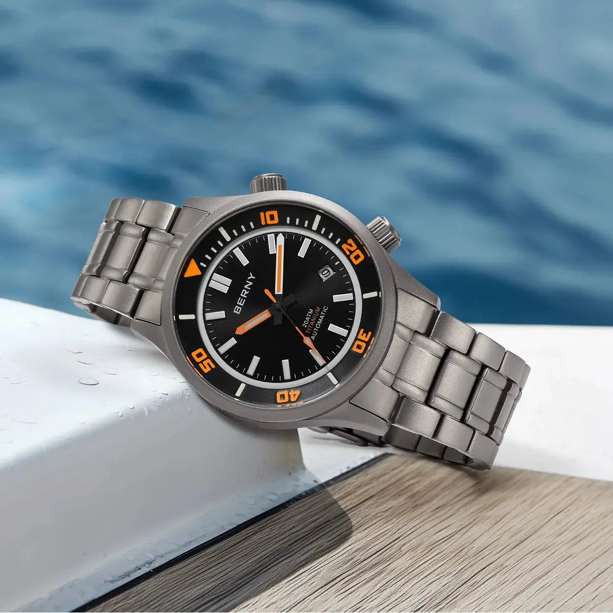 BERNY titanium automatic diver watch with black dial, orange bezel numerals, and titanium bracelet