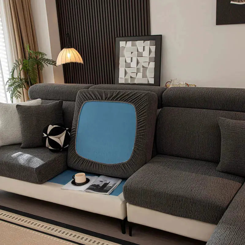Sofa cushion cover by Simples Market; thick plush elastic blue cover on a dark gray sectional.