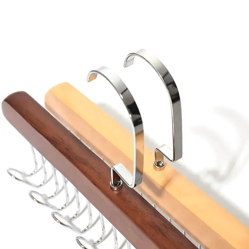 Bra hanger and wardrobe organizer by Simples Market with silver curved hooks on a wooden bar