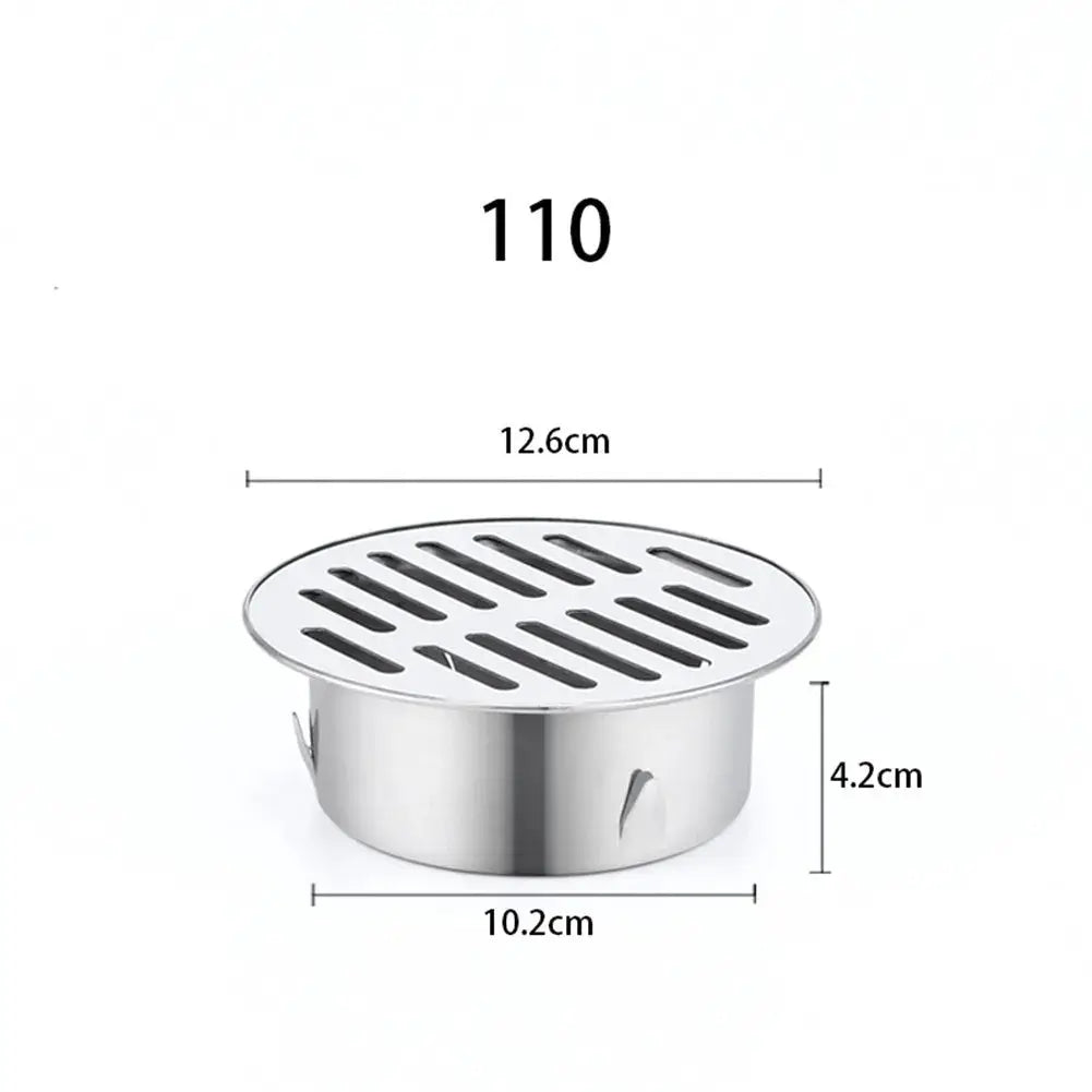 Floor drain, stainless steel round with slotted grate, 12.6 cm diameter and 4.2 cm tall.