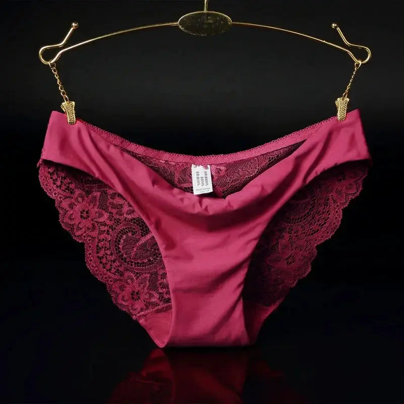 Pink lace panties, low-rise bikini style with floral lace sides, on a gold hanger.