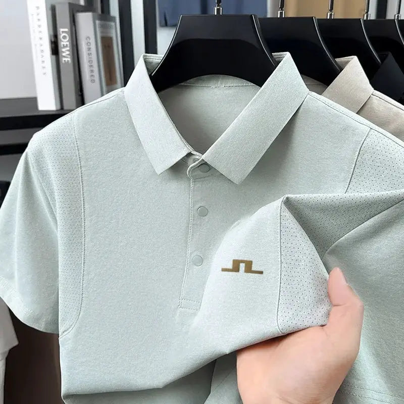 Men's polo shirt by Simples Market in pale mint with perforated side panels and a small gold chest logo