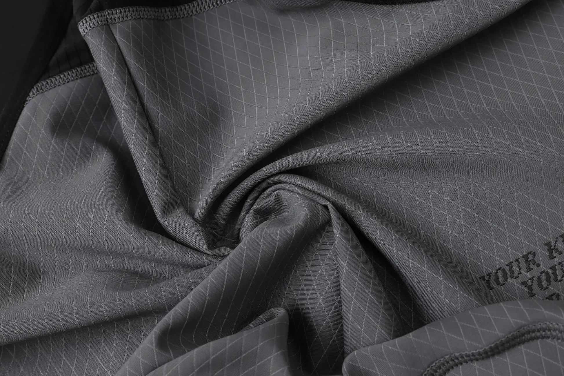 Cycling bib shorts fabric close-up in gray with a diamond grid pattern, Simples Market