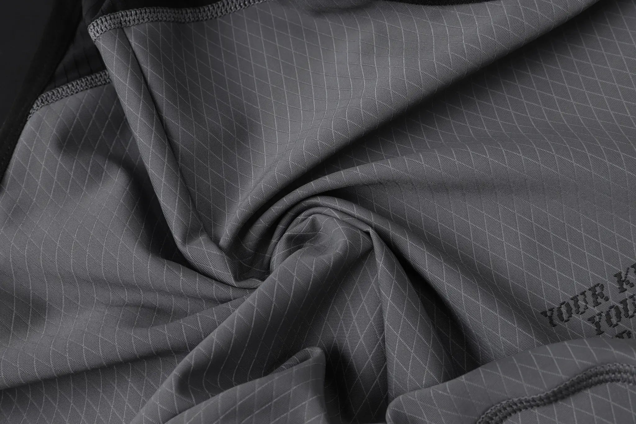Cycling bib shorts fabric close-up in gray with a diamond grid pattern, Simples Market