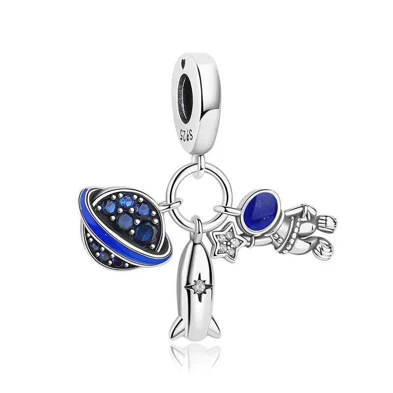Sterling silver space-themed charm cluster by Simples Market for bracelets and necklaces with rocket and planetary charms.