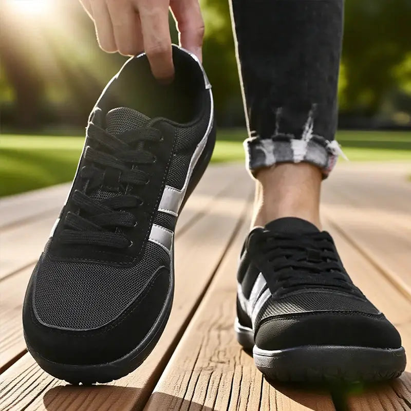 Simples Market pair of wide running shoes, black breathable mesh upper with silver stripes and anti-slip sole