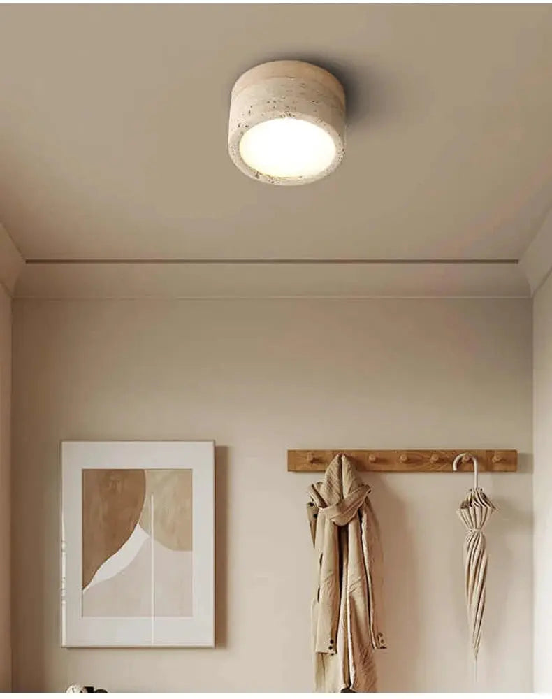 Stone LED ceiling light, cream color with Wabi Sabi style, mounted on beige ceiling.