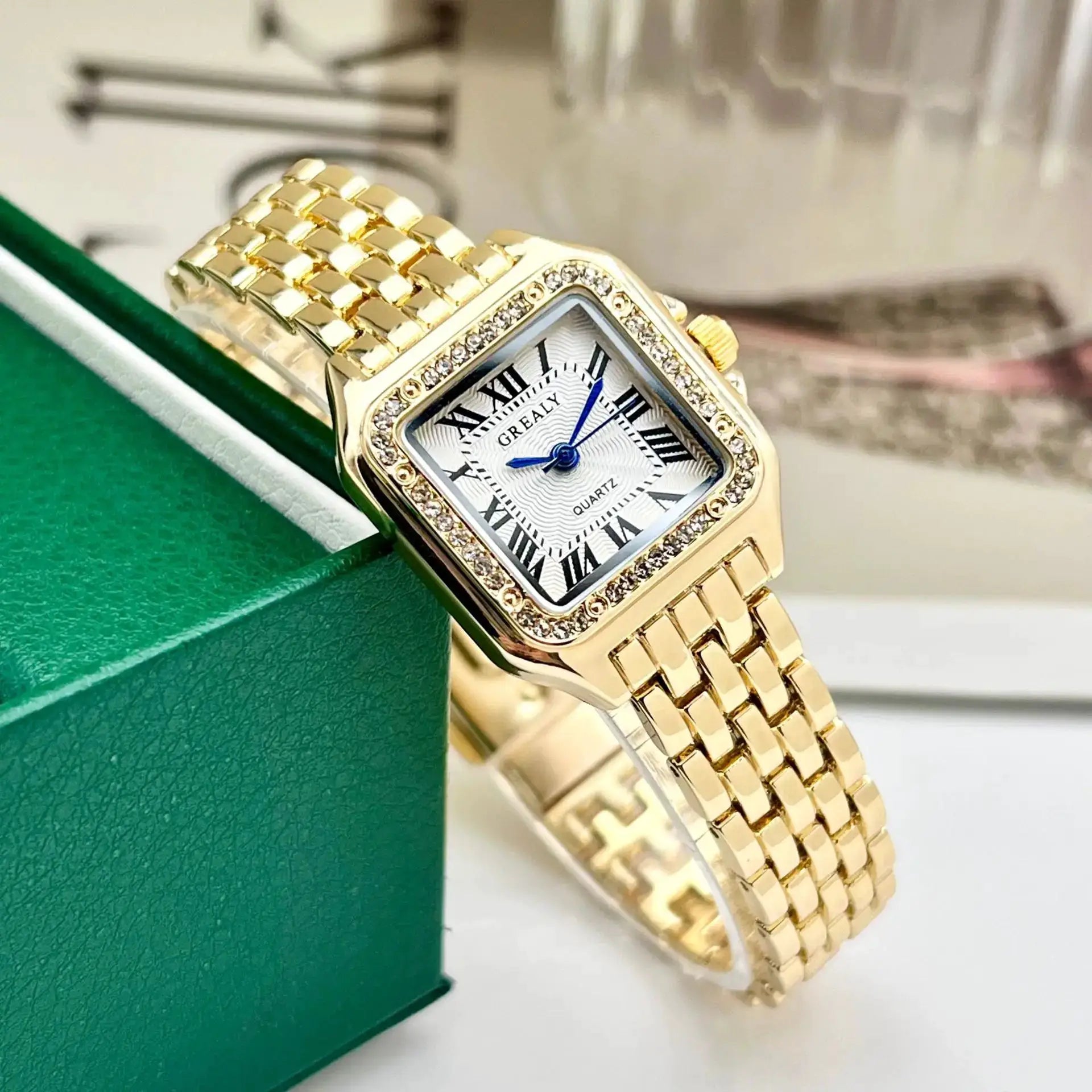 Gold-tone women's square stainless steel wristwatch with crystal bezel and Roman numeral dial
