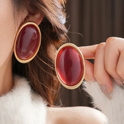 Simples Market pair of vintage red resin oval stud earrings with gold-tone frames