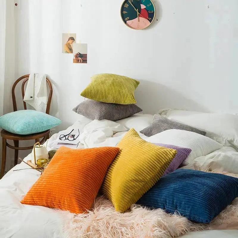Corduroy pillow covers by Simples Market in assorted colors; cushion set on bed and chair