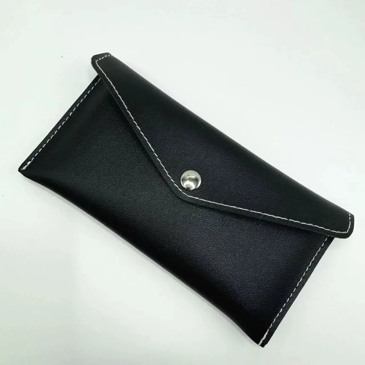 Unisex long black leather wallet with white stitching and snap closure by Simples Market