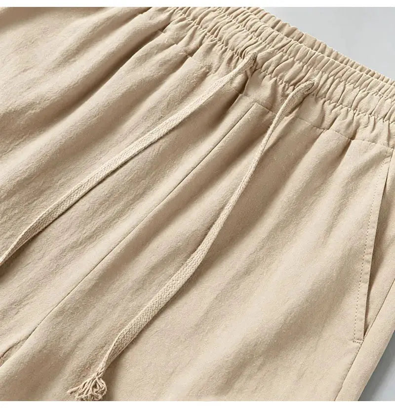 Men's cotton-linen blend cargo jogger pants in beige with elastic waist, drawstring, and multiple pockets