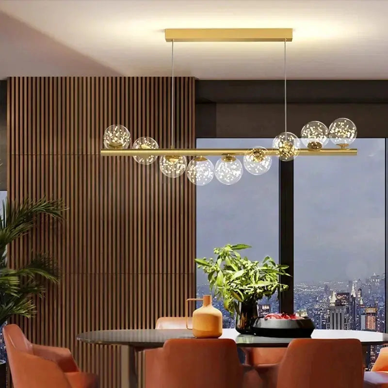 Nordic ceiling chandelier with gold finish and glass globe bulbs, suspended from a horizontal bar