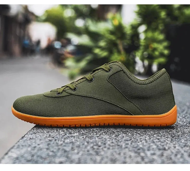 Trail running shoe with olive green mesh upper and orange outsole