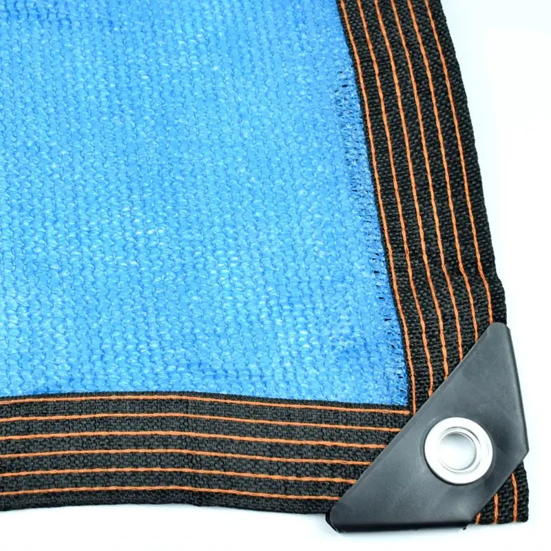 Blue HDPE sunshade net with black border and orange stitching, corner grommet