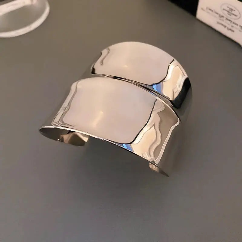 Metal cuff bracelet with multi-layer geometric design in silver iron alloy for women.