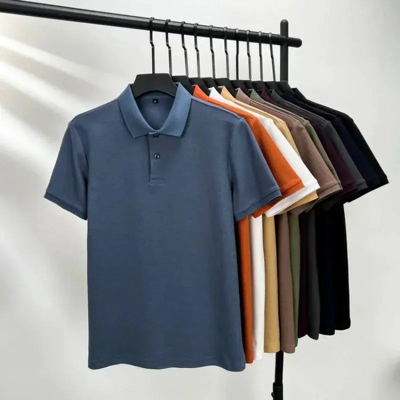 Simples Market men's polo shirt, 100% cotton with silk-like finish, blue front among assorted colors on hangers.