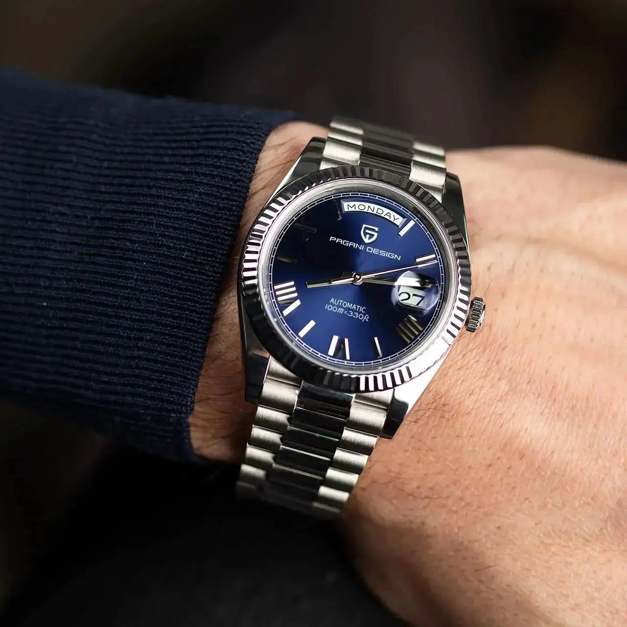 Pagani Design DD36 men's stainless steel watch on wrist with blue dial and day/date window
