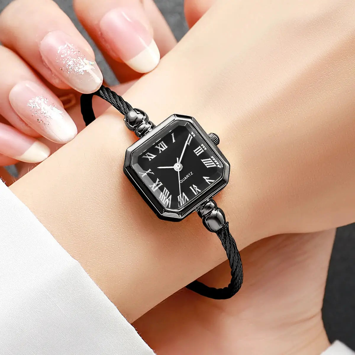 Women's square dial quartz wristwatch with black Roman numeral dial and braided bracelet strap