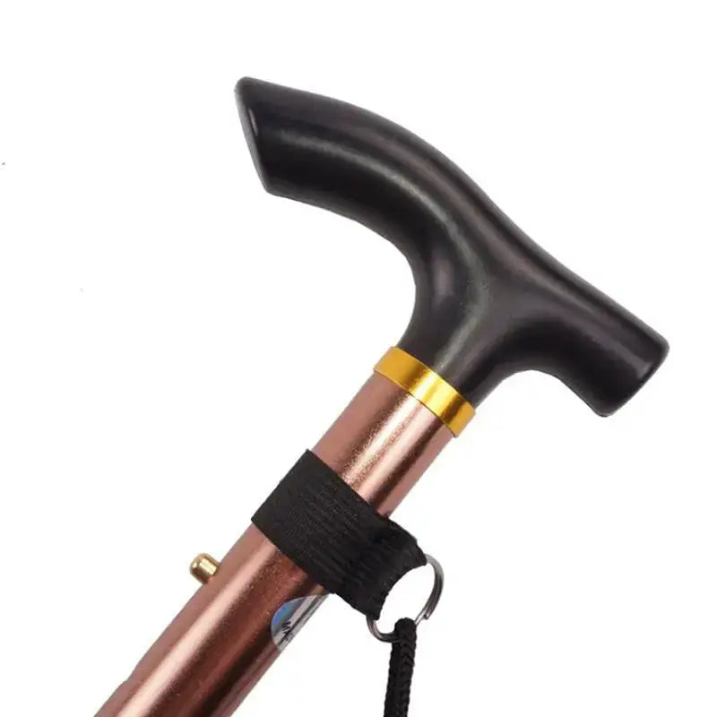 Telescopic walking stick with black T-handle, copper-tone shaft and wrist strap